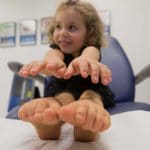 Girl Stretching on Bed — Podiatrists in Alice Springs, NT